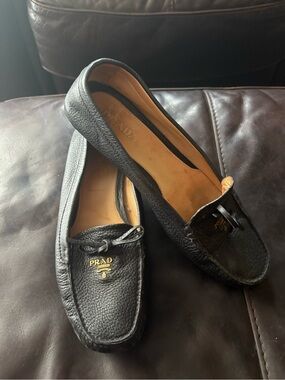Prada Black Pebbled Leather Moccasin Loafers with Gold Logo